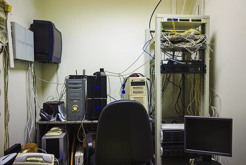Valcom Power of Integration.The workplace of the system administrator. A small, messy room with a table with a lot of monitors and a network server